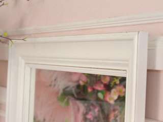 This gorgeous mirror features a frame that has been painted white 