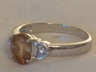   GOLD LADIES RING INSET WITH A FACETED CUT CITRINE AND WHITE STONES