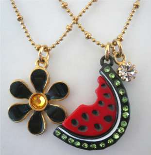   green rhinestones, and black flower. Necklace measure approximately 15