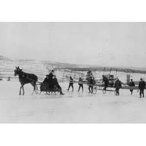  A horse drawn sleigh pulls as men guide the Silver Dart 