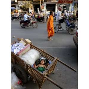 Small Child Sleeps in a Cart on the Streets of Phnom Penh, Cambodia 