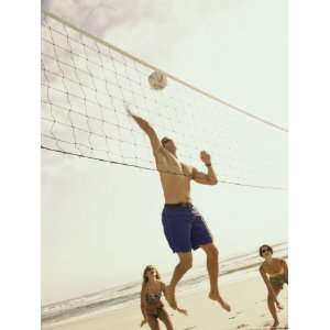 Low Angle View of Three People Playing Volleyball on The Beach Premium 